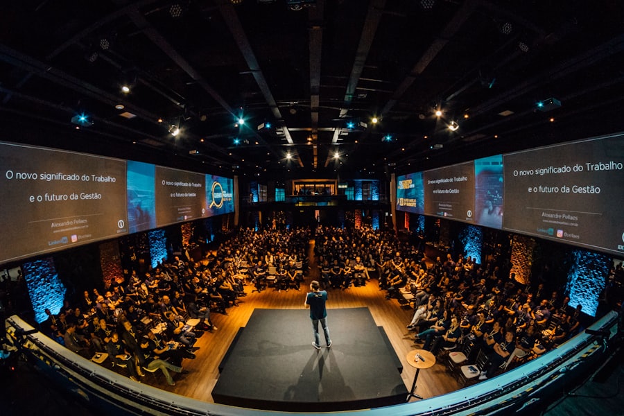Speaker on stage before a large audience